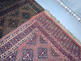 a rug on the floor with a cat sitting on it