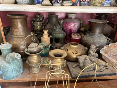 many vases on a shelf in a room