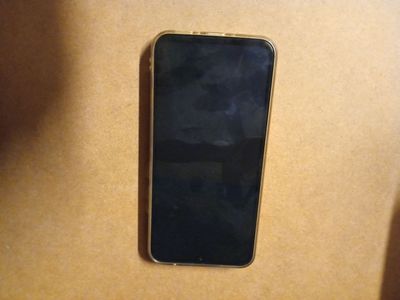 an iphone is sitting on top of a cardboard box on a table