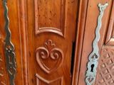a close up of a wooden door with a heart on it