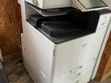 a stack of office printers sitting on top of each other