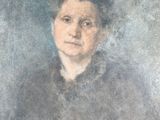 portrait of a woman in a black dress by a blue background