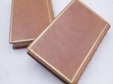 two books that are sitting on a white surface