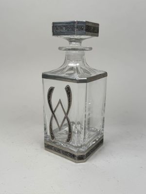 an image of a glass bottle with a metal handle