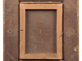 an old wooden frame with a label on it