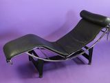 black leather chaise lounger with chrome frame and foot rest