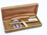 a box with a pen and a pair of scissors in it