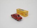 an old red toy car sitting next to a box of cigarettes