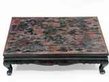 a small table with a red and black design on it