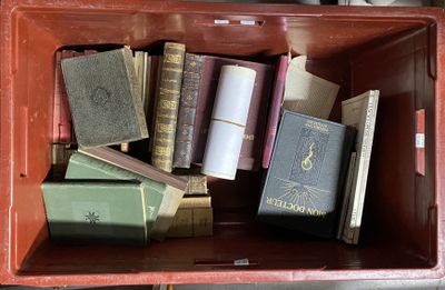 many books in a red box on the floor