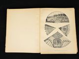 an open book on a black table with a picture of a building
