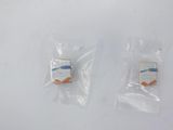 two small plastic bags of food sitting on top of a white surface