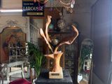 a statue of a deer head on a pedestal in a room
