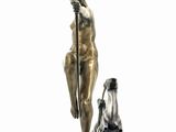 statue of a woman holding a spear and a man sitting on a box