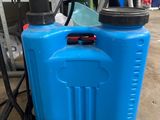 a blue sprayer sitting on top of a table next to a black hose