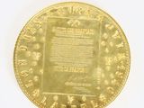 an image of a gold coin on a white surface