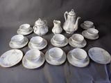 a lot of tea cups and saucers on the table