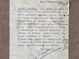 an old piece of paper with a letter on it sitting on top of a table