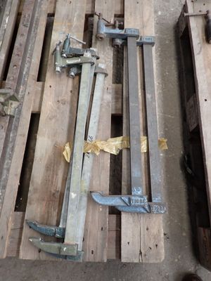 several pieces of wood sit on top of pallets in a warehouse