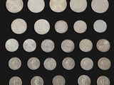 a group of twenty different british coins on a black background