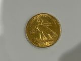 a gold coin sitting on top of a white surface