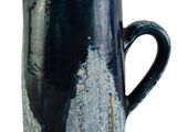 a blue and black pitcher that is sitting on a table