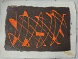 une photo représentant un dessin orange et noir sur une feuille de papier