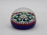 a glass ball with a flower inside of it on a table