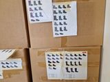 boxes of shoes are stacked on top of each other with stickers on them