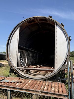 a large barrel sitting in the middle of a field