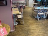 many tables and chairs in this restaurant with wood flooring