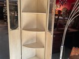 a corner cabinet in the middle of a room