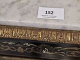a marble table with a gold frame on top of it