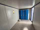 two blue doors in the hallway of a building