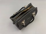a black purse sitting on top of a white table