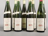 several bottles of wine are lined up on a table