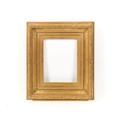 a gold picture frame on a white wall with a white background