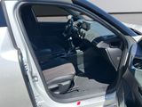 a car with the door open and the driver ' s seat down