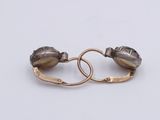 pair of silver and gold hoop earrings on a white background
