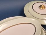 two plates and a bowl on a blue table