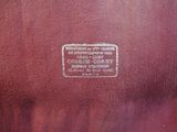 the back of a brown leather chair with a label on it