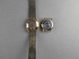 an image of a couple of watches sitting on top of a table
