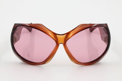 a close up of a pair of sunglasses on a white surface