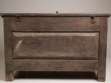 an old wooden chest sitting on a white surface