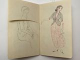 an open book with a drawing of a woman sitting on a chair