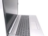 a silver laptop computer sitting on top of a white table