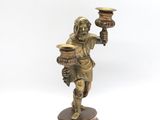 an image of a statue of a man holding a pot and a candle