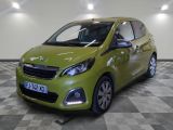 the small green car is parked on a checkered floor