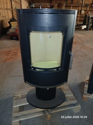 a black stove sitting on top of a pallet in a warehouse
