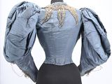 an image of a mannequin with a blue blouse and black skirt on a mannequin